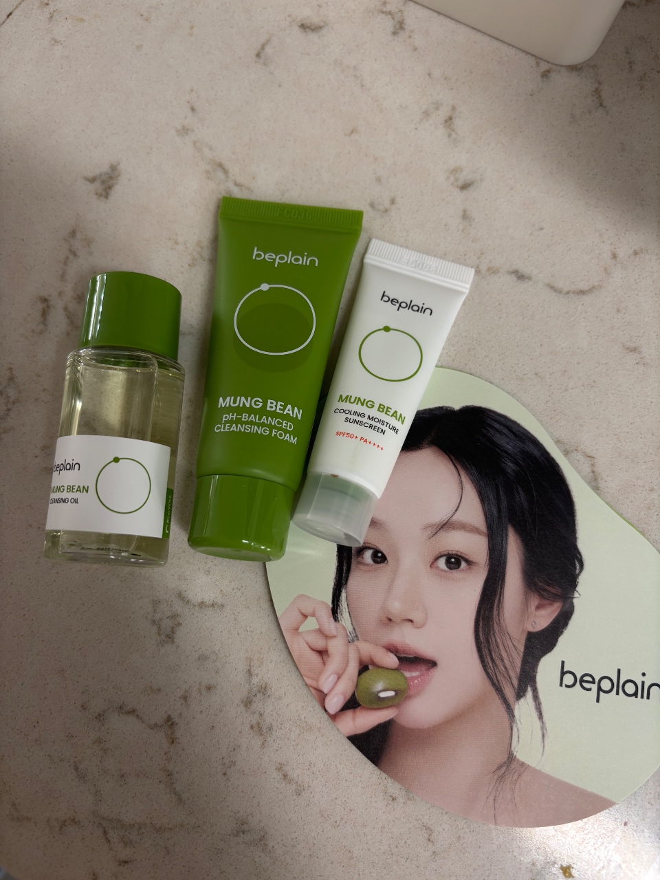콩 성분 스킨케어 제품과 모델 얼굴이 담긴 브랜드 광고물