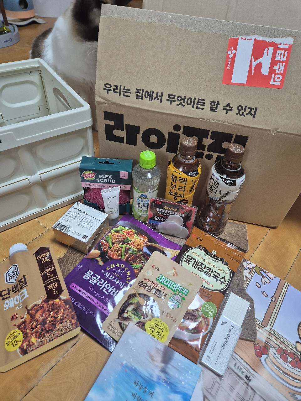 배송 상자와 함께 펼쳐진 한식 간식, 소스, 스크럽 제품들